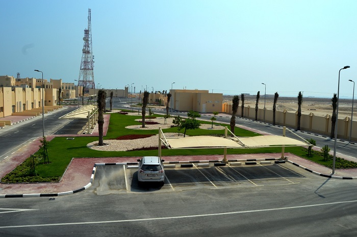Landscaped compound with lawn, palms and paved areas built by Al Noaimi in Qatar